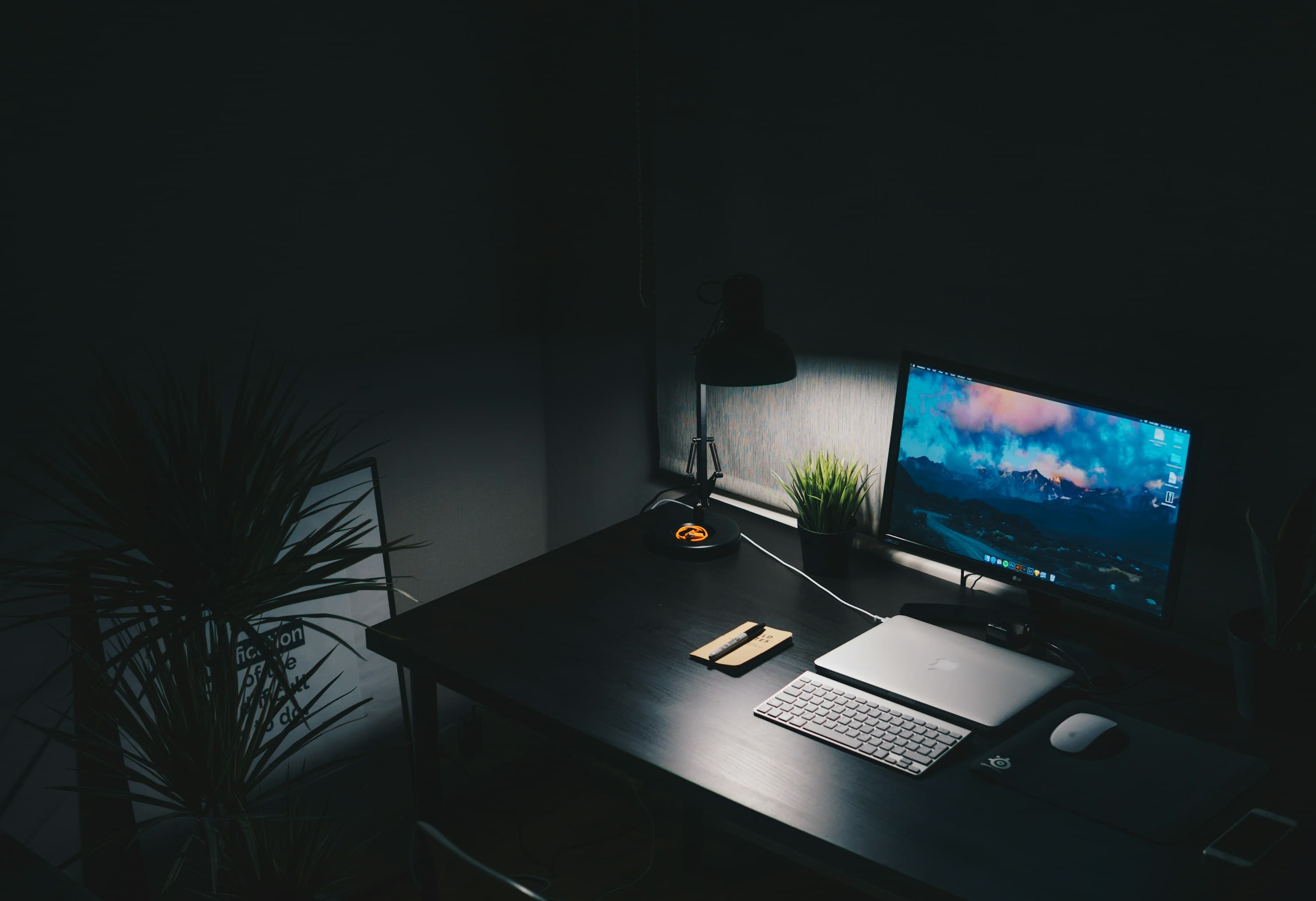 A quiet, dimly lit desk setup at night