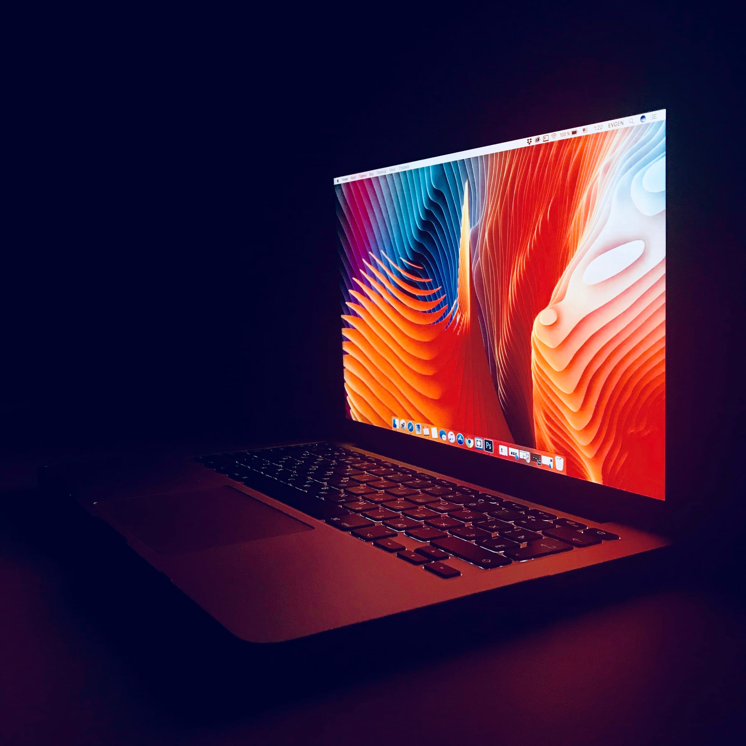 A MacBook in a dim room, ready to be boxed up